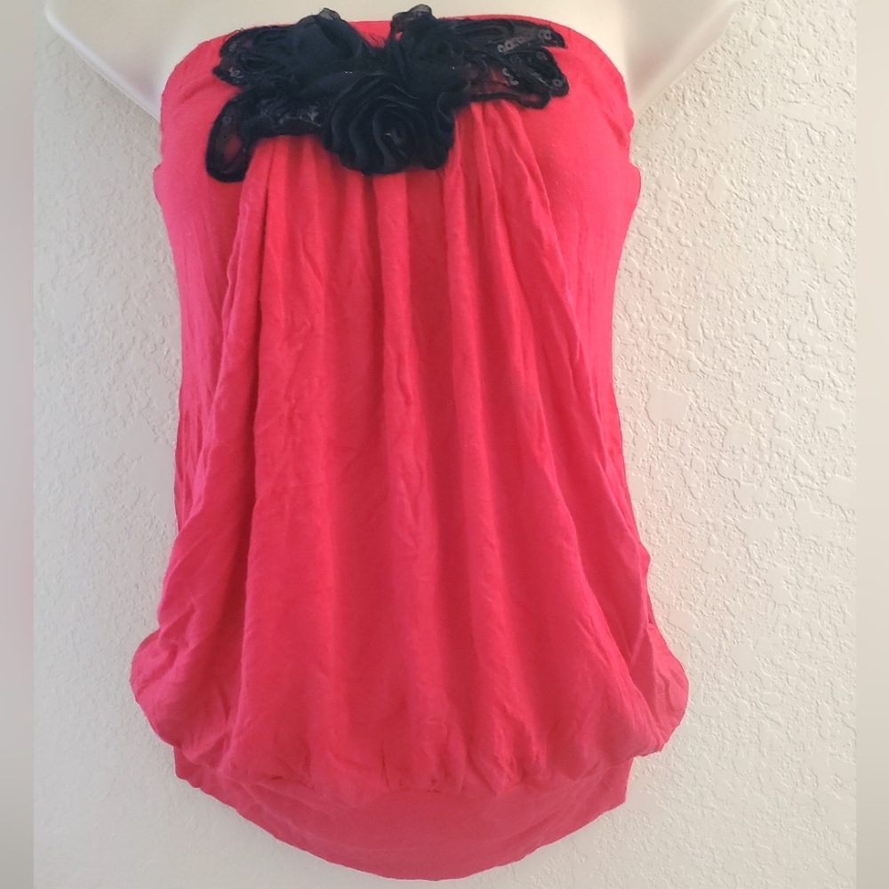 Sleeveless top with floral embellishments.
